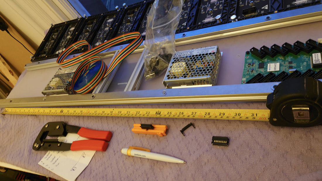 Technical components and tools on a table with a ruler for scale.
