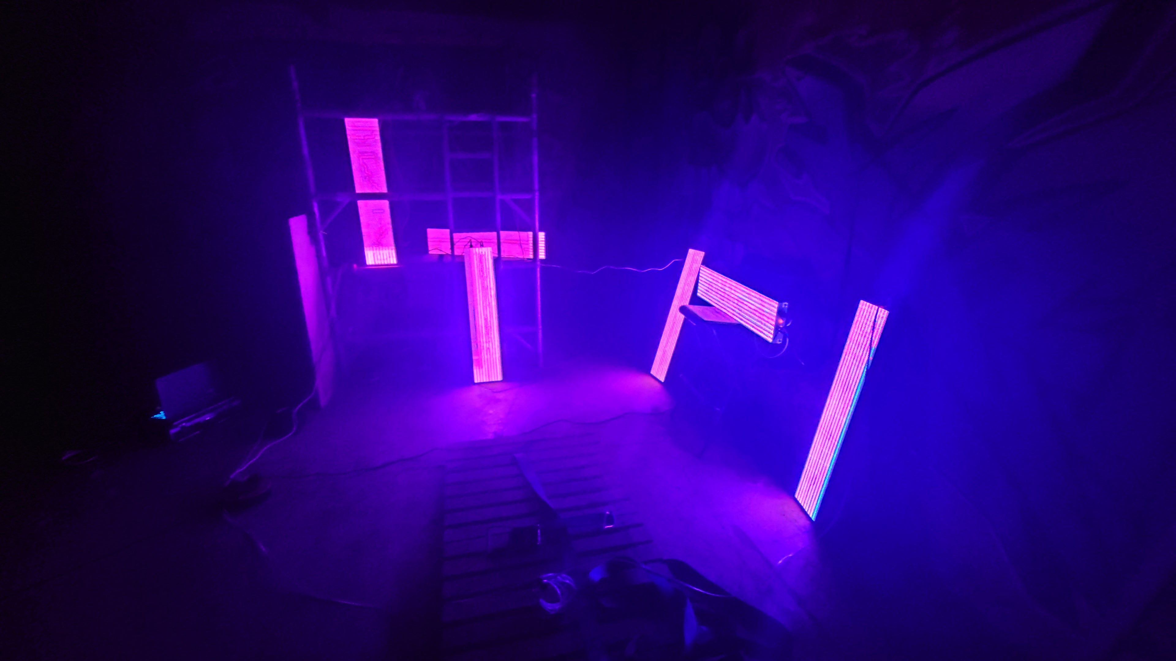 Load video: Video of LED panels flashing and being used in a warehouse setting with graffiti on the walls.