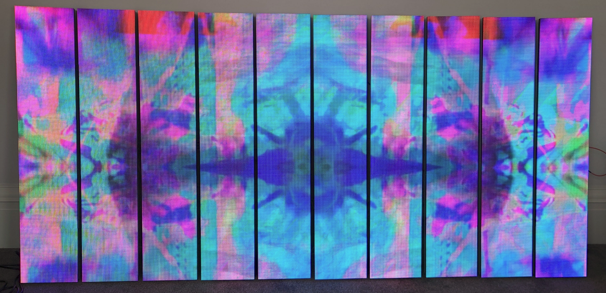 Multicolored abstract pattern on a LED screen leaning against a wall