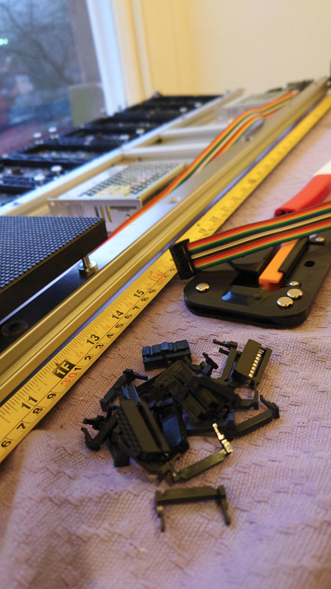 Black electronic components on a textured surface with a ruler in the background