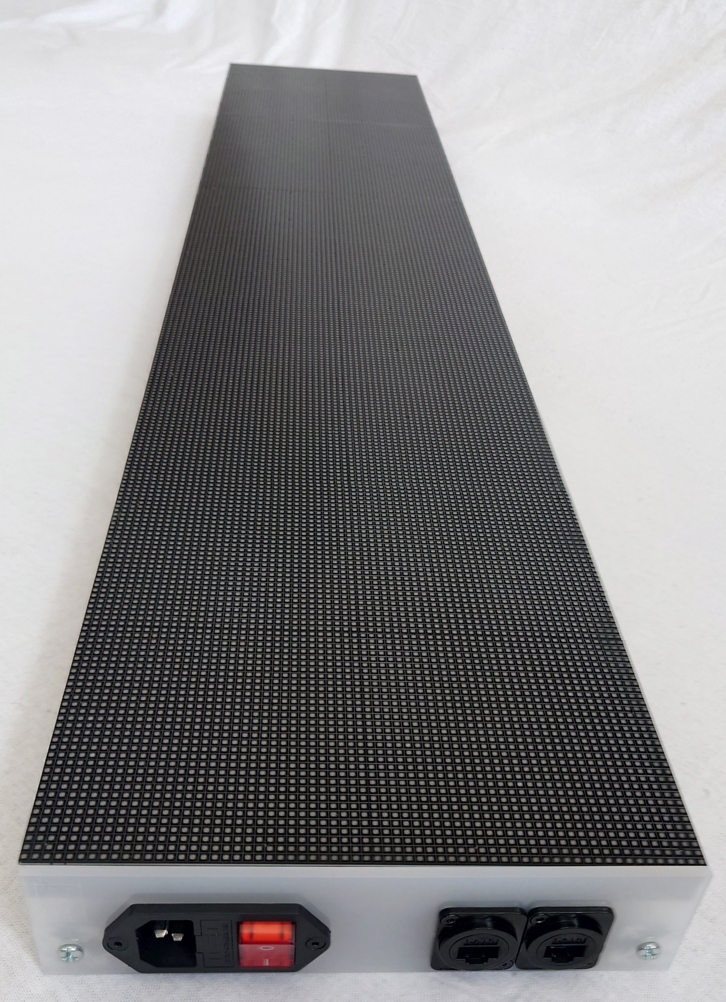 An LED panel showing the base board with a power port and 2 network ports panel mounted onto the white opaque acrylic on a white background