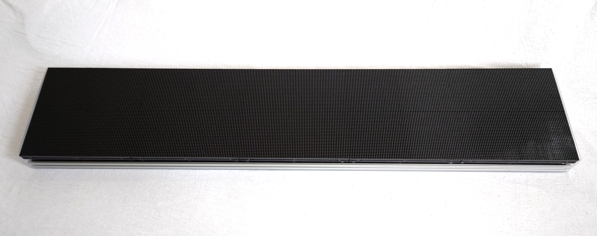 A rectangular LED panel from the side showing the 2020 extruded aluminium frame on a white background
