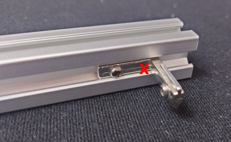 If the L-bracket slides down the track it is incorrectly aligned!