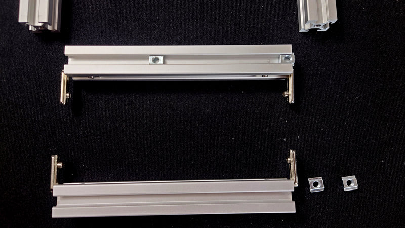 Align the cross bars as shown before sliding T-nuts onto tracks