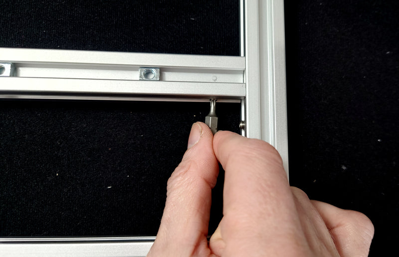 Tighten the L-bracket onto the crossbar so the side bar is flush against the cross bar end
