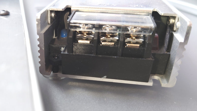Slide the PSU onto the screw that has the nut already attached