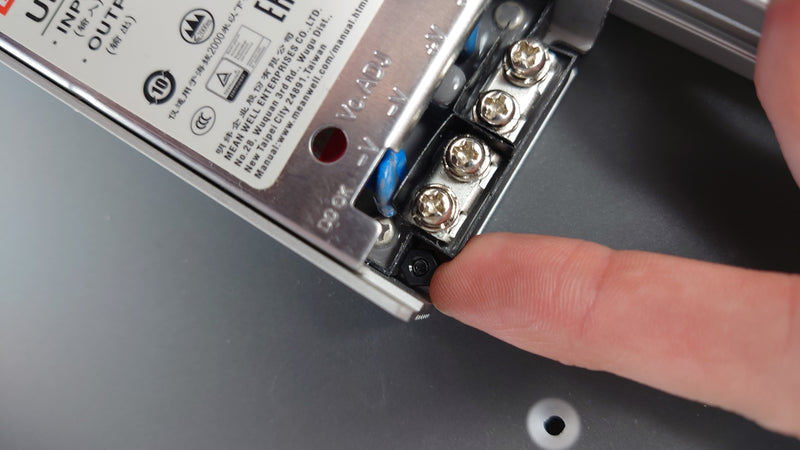 Holding the nuts still with a finger to tighten the screws