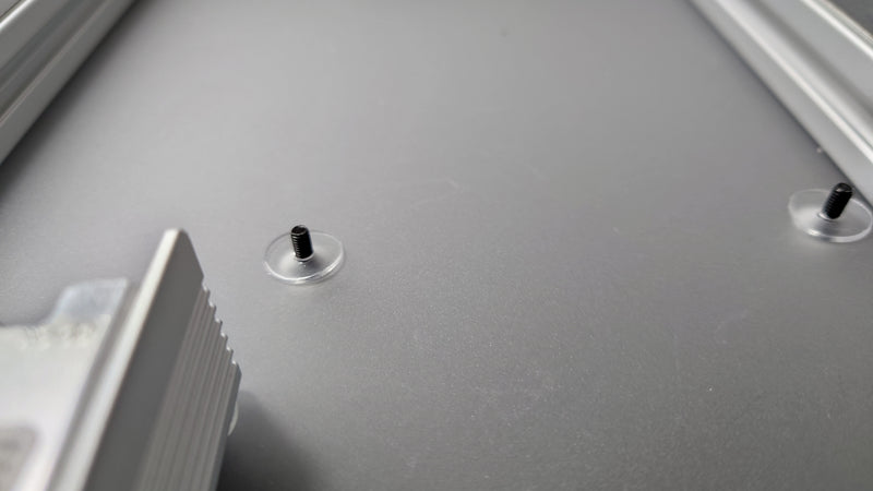 Screws through the back plate with washers